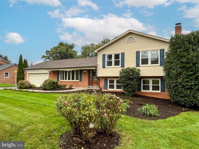 tri-level home with a garage and a front lawn