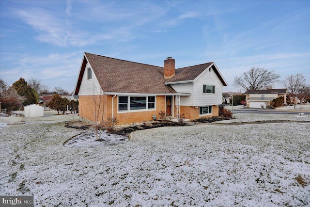 view of snow covered rear of property