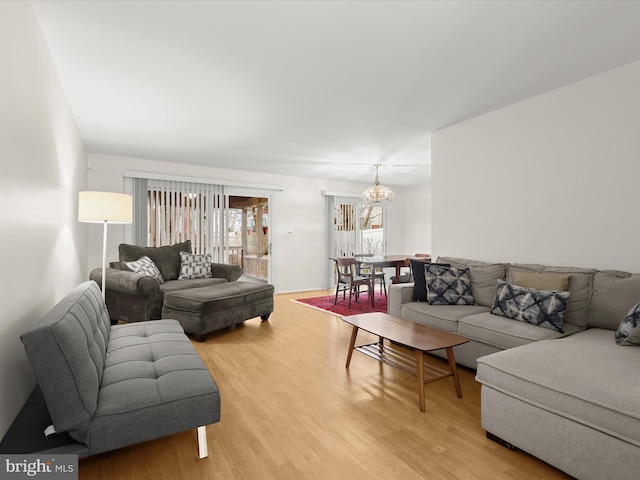 living room featuring a chandelier and wood finished floors