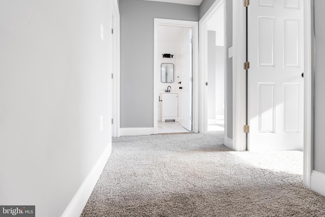 hallway with light colored carpet