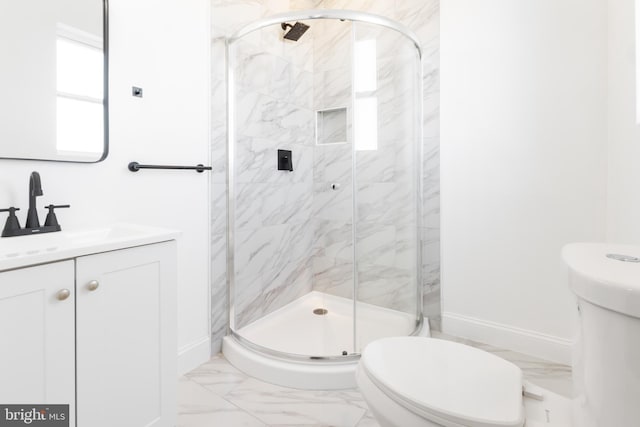 bathroom with toilet, an enclosed shower, and vanity