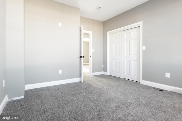 unfurnished bedroom with carpet and a closet