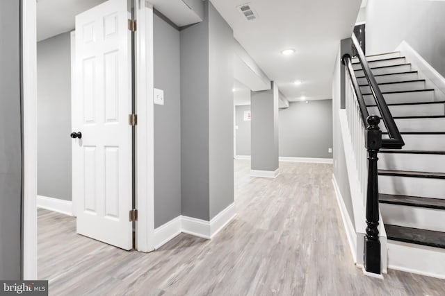 hallway with light hardwood / wood-style flooring