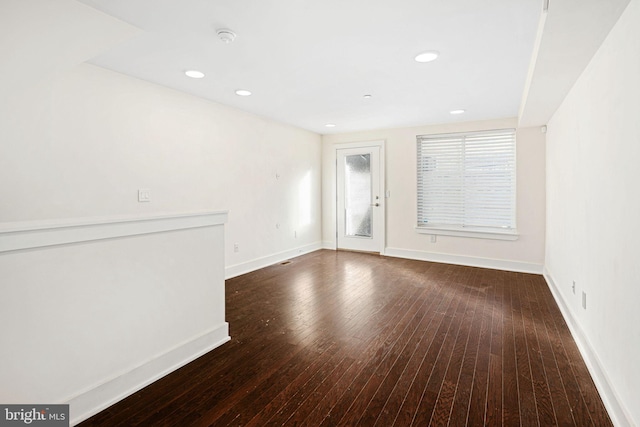 spare room featuring dark hardwood / wood-style floors