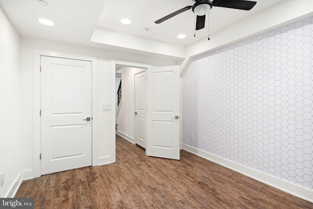 unfurnished bedroom featuring wood-type flooring, a closet, and ceiling fan