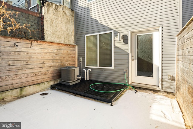 property entrance featuring central AC unit and a patio area