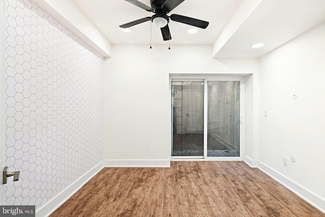 unfurnished bedroom with ceiling fan and hardwood / wood-style flooring