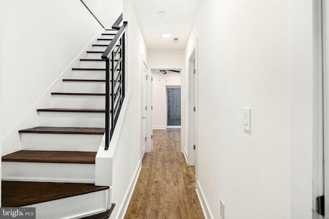 staircase with wood-type flooring