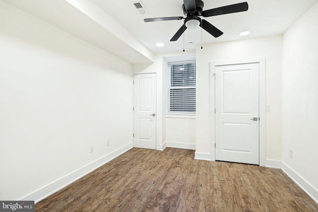 unfurnished bedroom with ceiling fan and wood-type flooring