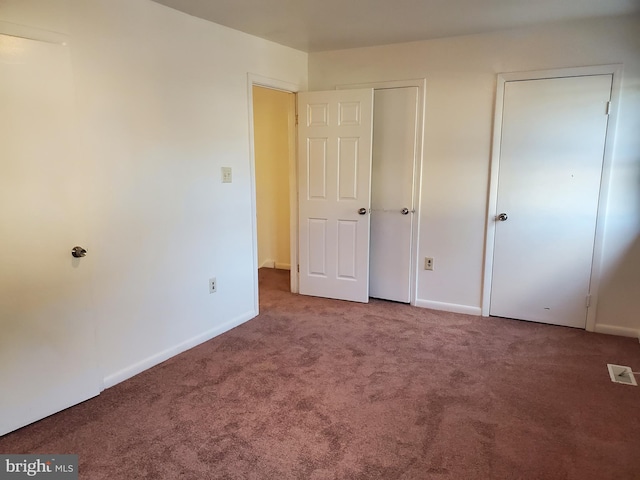 unfurnished bedroom with carpet floors