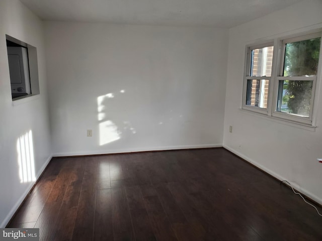 spare room featuring dark wood-type flooring