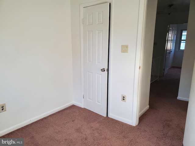 unfurnished bedroom featuring dark carpet