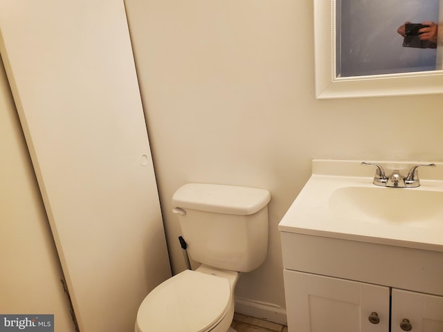 bathroom featuring toilet and vanity