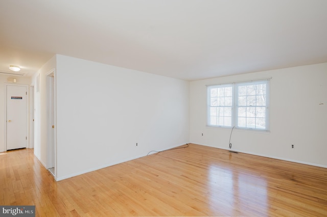 empty room with light hardwood / wood-style flooring