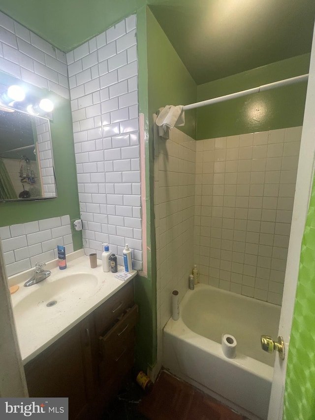 bathroom featuring vanity, bathtub / shower combination, and tasteful backsplash