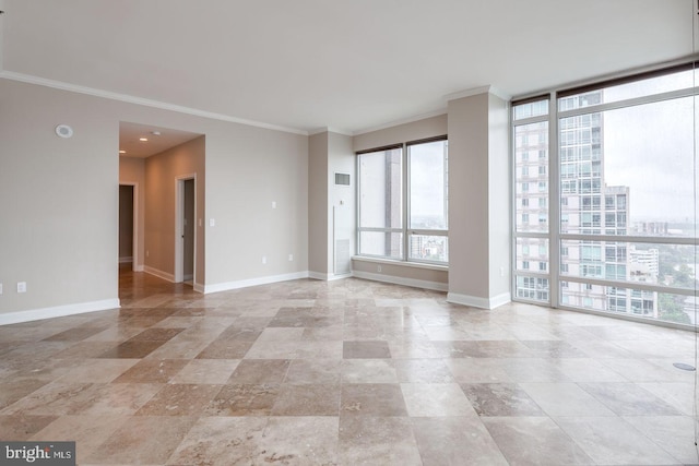 empty room featuring a wall of windows and crown molding