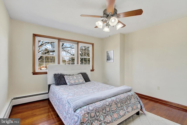 bedroom with a baseboard radiator, baseboards, ceiling fan, and hardwood / wood-style floors