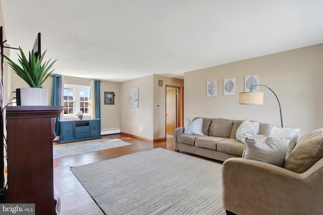 living area featuring baseboard heating, wood finished floors, and baseboards