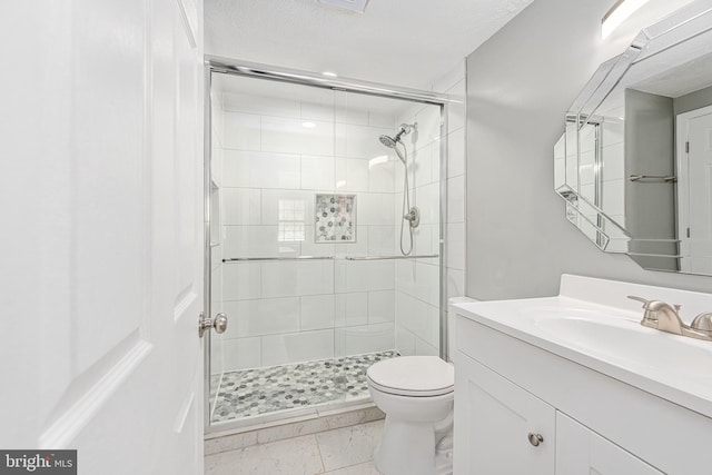 bathroom with tile patterned floors, a textured ceiling, an enclosed shower, toilet, and vanity