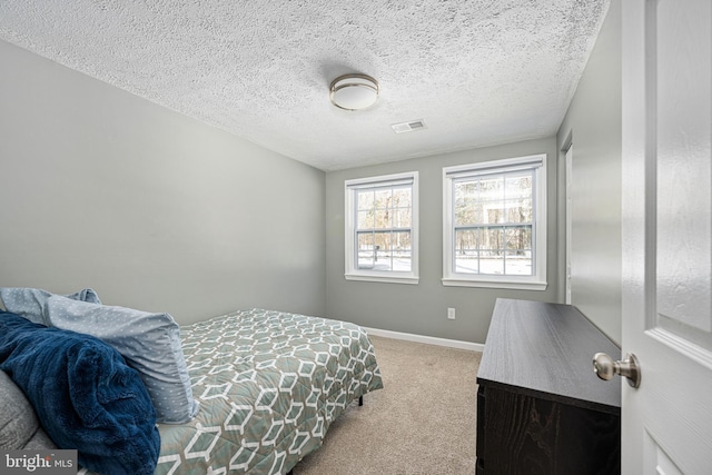 carpeted bedroom with a textured ceiling