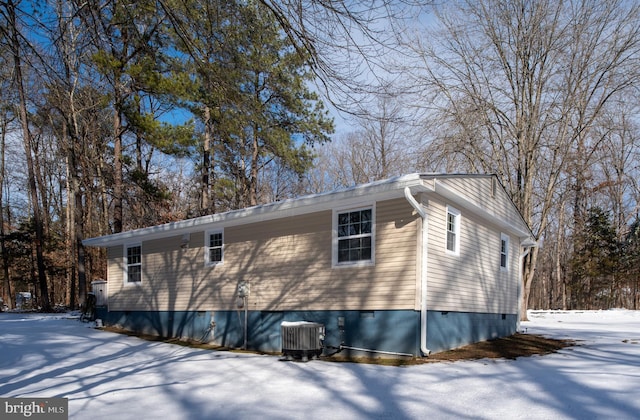 snow covered property featuring cooling unit