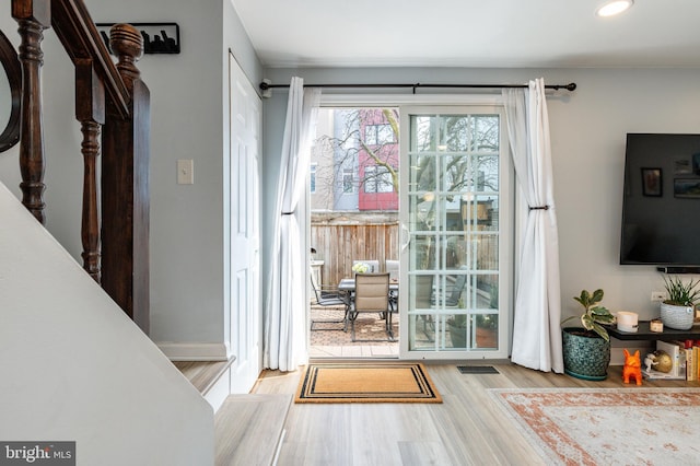 doorway to outside with light wood-type flooring