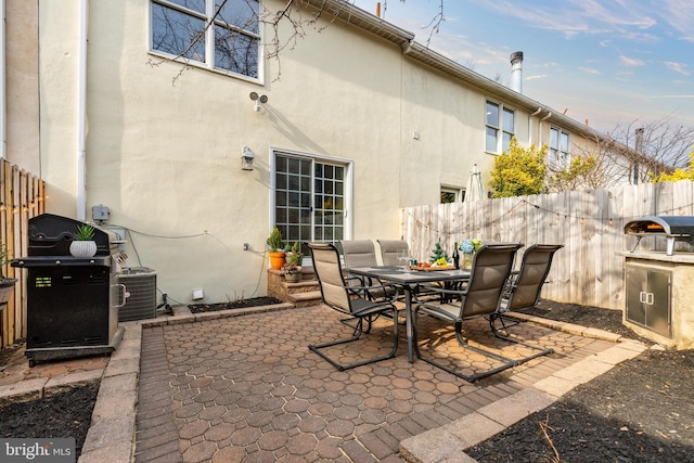 view of patio / terrace with a grill and central AC unit