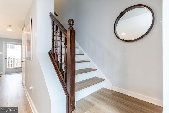 stairway with hardwood / wood-style flooring