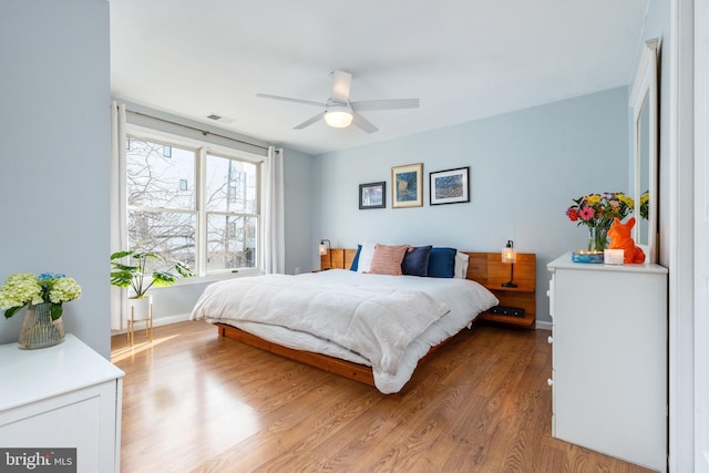 bedroom featuring light hardwood / wood-style floors and ceiling fan