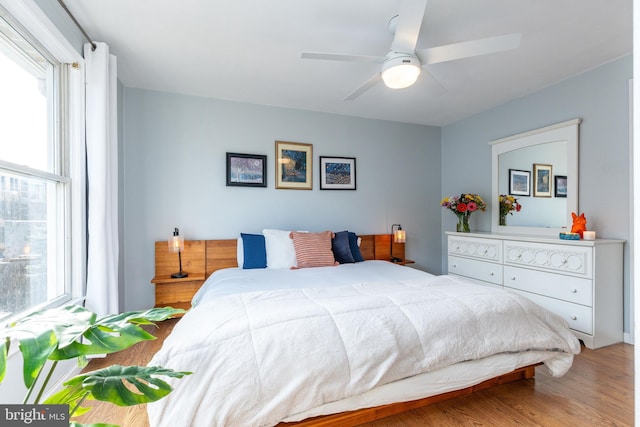 bedroom with ceiling fan and wood-type flooring