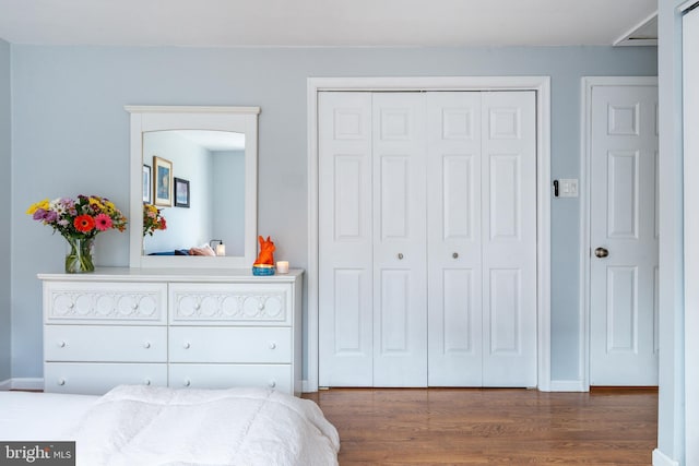 bedroom with dark hardwood / wood-style floors