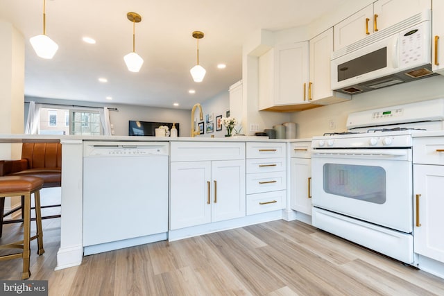 kitchen featuring kitchen peninsula, white appliances, white cabinetry, and hanging light fixtures