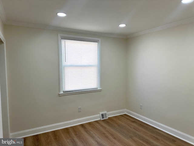 unfurnished room with hardwood / wood-style floors and ornamental molding