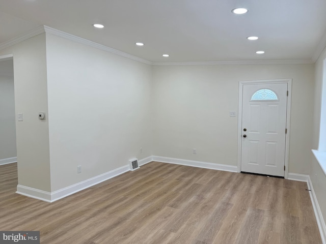 entryway with crown molding and light wood-type flooring