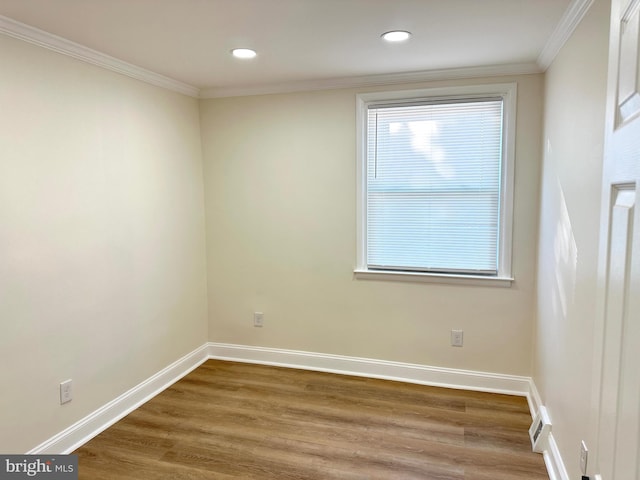 unfurnished room with wood-type flooring and ornamental molding