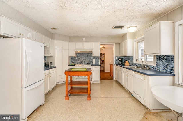 kitchen with sink, white appliances, and white cabinets