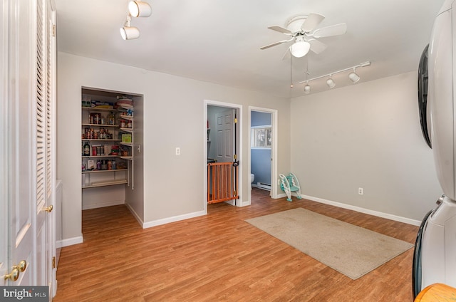 interior space featuring ceiling fan, light hardwood / wood-style floors, and a closet