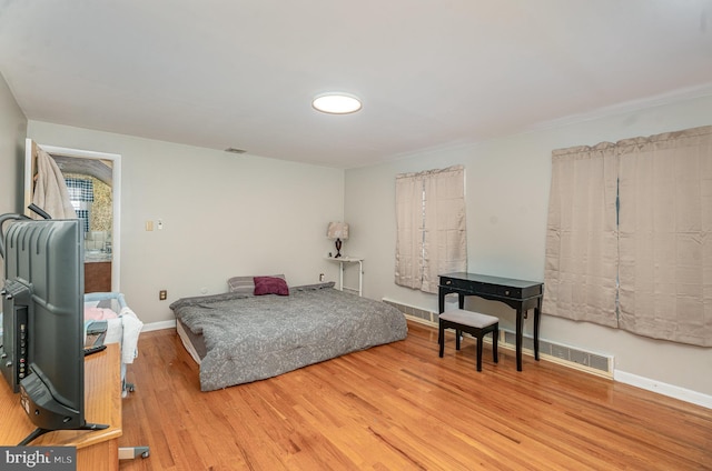 bedroom with hardwood / wood-style flooring