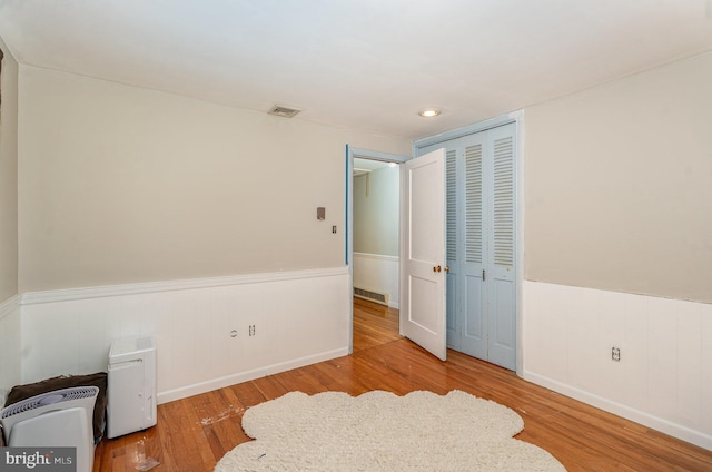 bedroom featuring light wood-type flooring and a closet