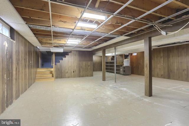 basement featuring wood walls