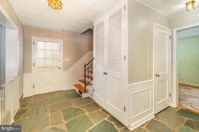 foyer featuring a textured ceiling