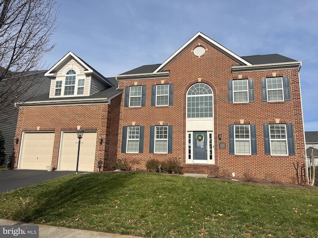 view of front of house featuring a front lawn and a garage