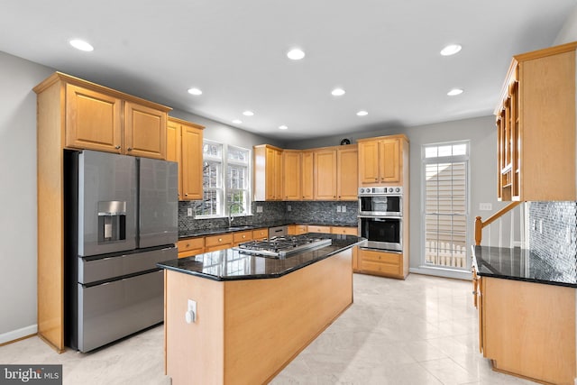 kitchen with backsplash, recessed lighting, appliances with stainless steel finishes, and a sink