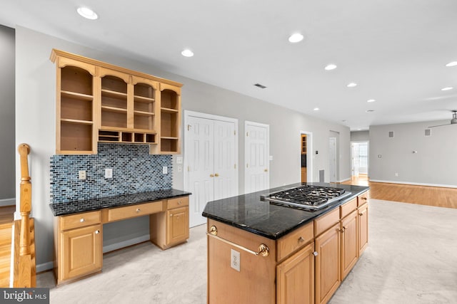 kitchen with backsplash, a kitchen island, stainless steel gas cooktop, built in study area, and open shelves