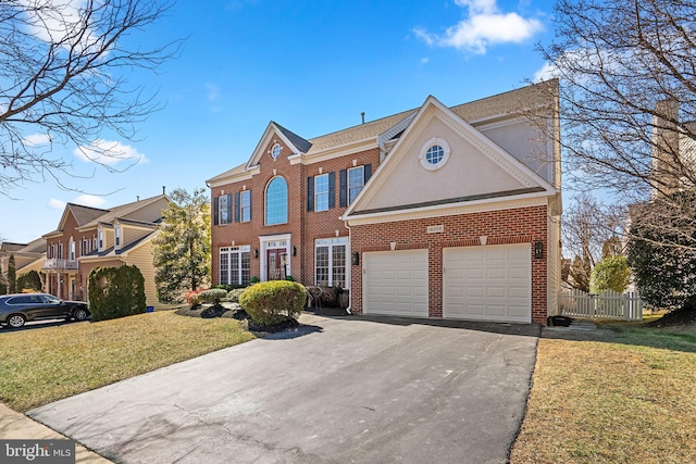 view of front of property featuring brick siding, fence, aphalt driveway, a front yard, and an attached garage