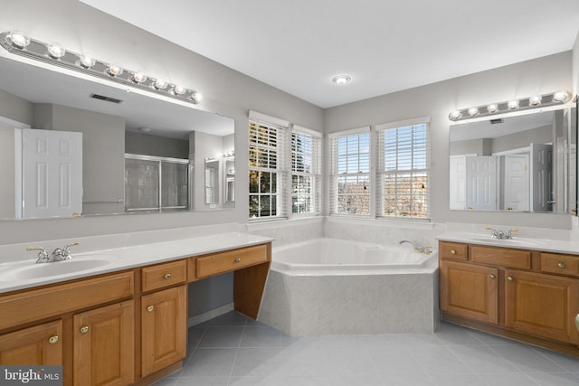 bathroom with a sink, a bath, a shower stall, and tile patterned floors