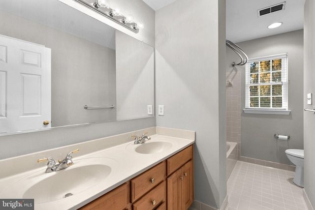 bathroom featuring tile patterned flooring, visible vents, toilet, and a sink