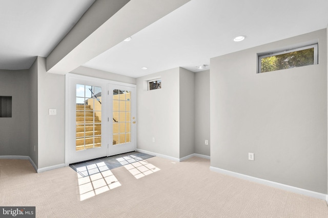 entryway featuring baseboards, carpet, and a healthy amount of sunlight