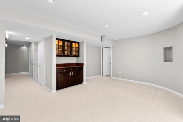 unfurnished room with recessed lighting, baseboards, and light carpet