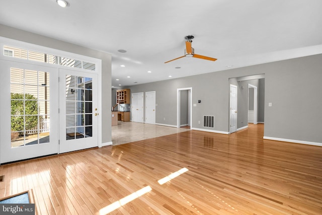 unfurnished living room featuring visible vents, a ceiling fan, recessed lighting, light wood-style floors, and baseboards